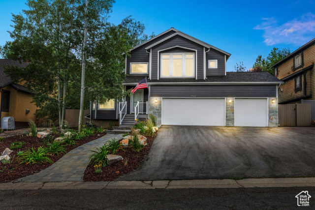 View of property with a three car garage