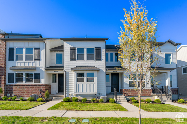 Multi unit property featuring cooling unit and a front lawn