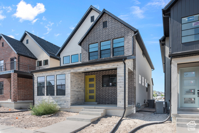 View of front of home featuring central AC unit