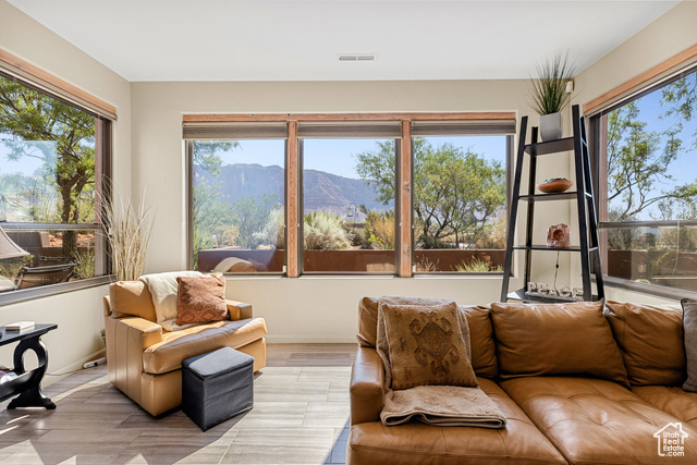 Sunroom featuring a mountain view and a wealth of natural light