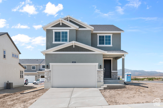 Craftsman-style home with a mountain view, central AC, and a garage