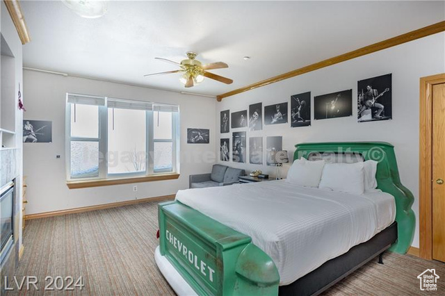 Bedroom with ceiling fan and ornamental molding