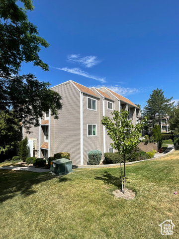 View of side of home featuring a lawn