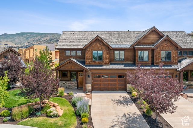 View of front facade with a garage and a mountain view