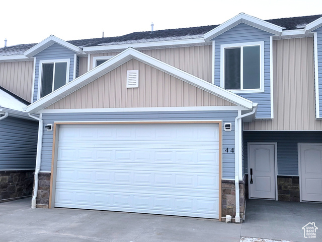 View of front facade featuring a garage