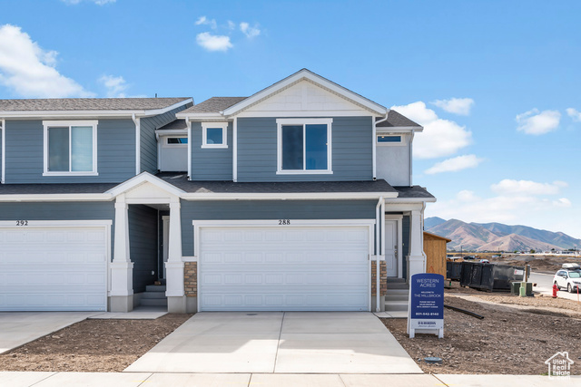 View of front of property featuring a mountain view and a garage