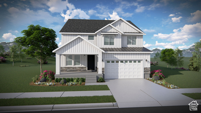 View of front of house featuring a garage and a front lawn