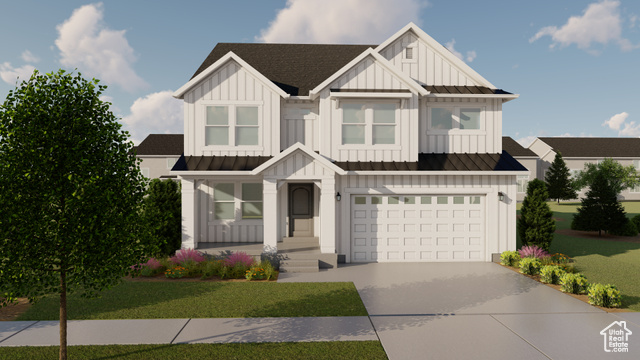 View of front of home with a garage and a front lawn