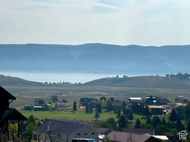 Property view of mountains with a water view