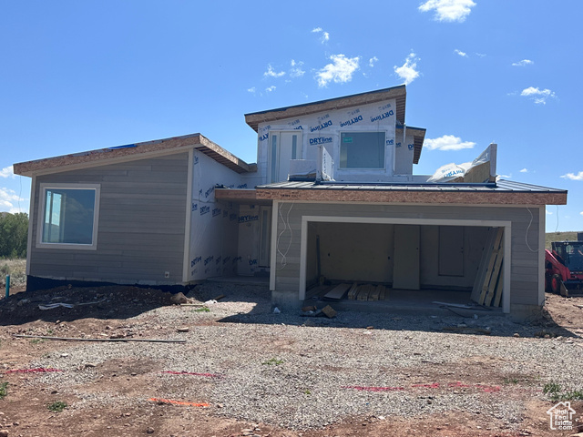 Property in mid-construction featuring a garage