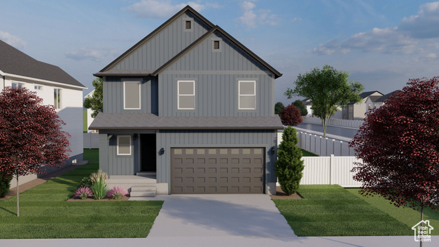 View of front of property featuring a garage and a front yard