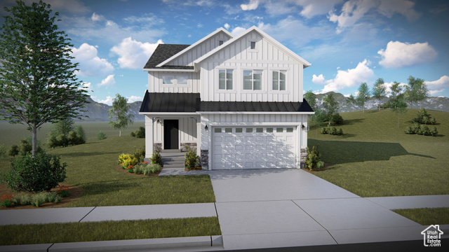 View of front of property with a garage and a front lawn