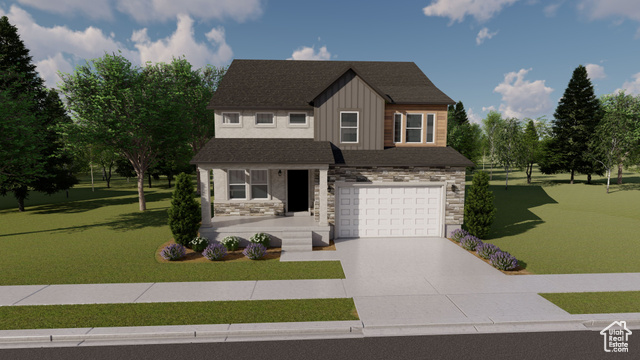 View of front of property featuring a garage and a front lawn