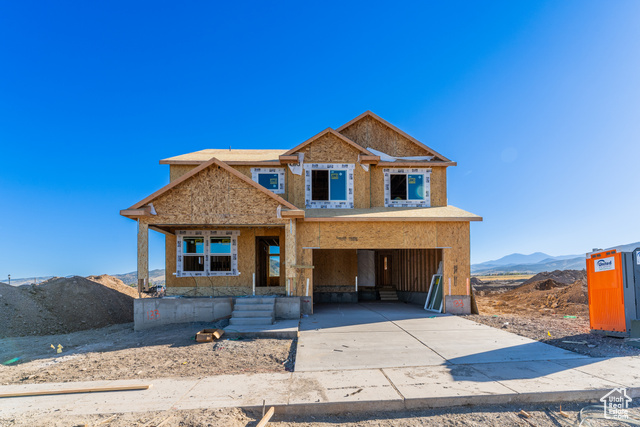 View of front facade featuring a mountain view and a garage