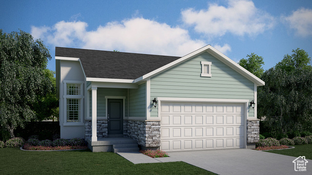 View of front of house with a garage and a front yard