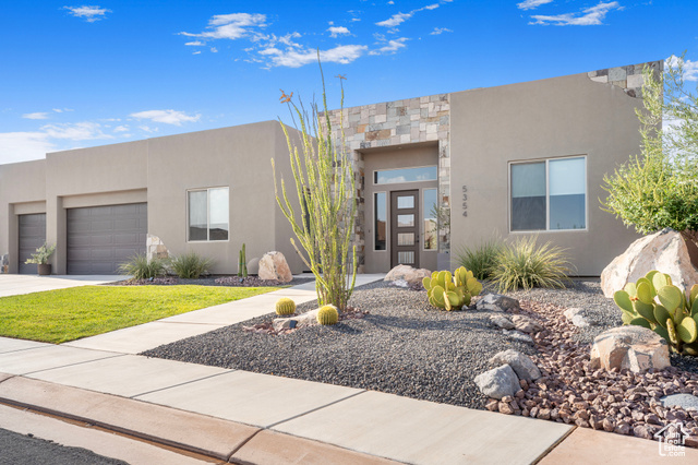 Pueblo-style home with a garage