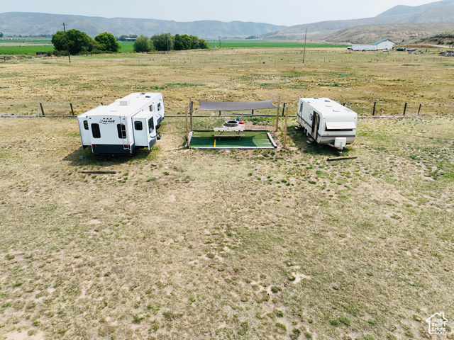 Step into this already set up income producing property with so much more potential! 7.68 acres of useable land with 6 irrigation shares. Property has been improved with water (private well), power, and septic tank. Currently being used as a VRBO. Two camp trailers are being rented on a nightly basis and open camping is also being advertised. A separate bathroom is installed as well including a toilet and shower. 2 of the 4 trailers on the property will be included in the sale of the land. This property is located just 10 minutes away from North Beach road.