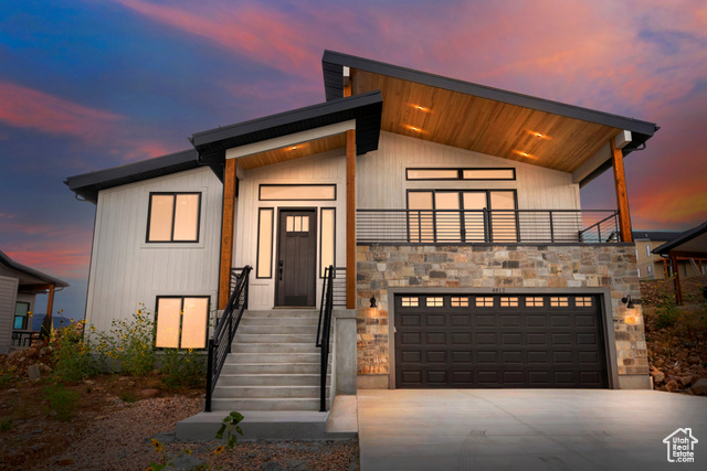 Contemporary home with a garage and a balcony