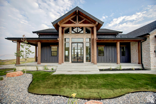 Back of house featuring a yard and a porch