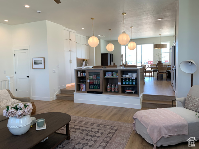 Living room featuring light wood-type flooring (photo of model in the community with same floor plan)