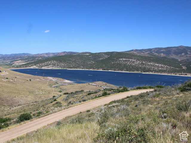 Birds eye view of property featuring a water and mountain view