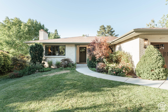 Ranch-style house with a front lawn