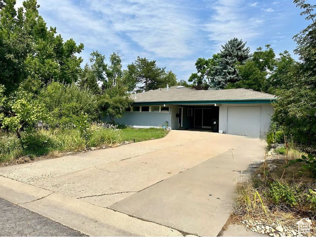 View of front of house with covered porch and garage