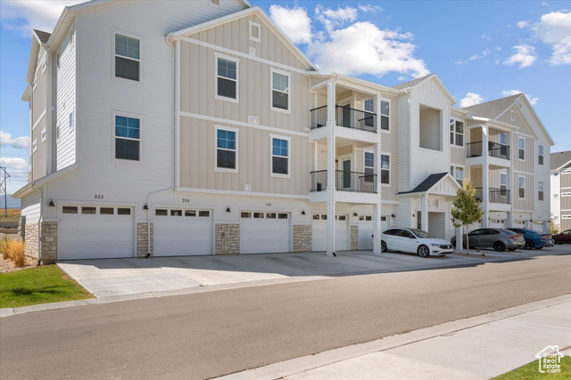 Exterior space featuring a balcony and a garage