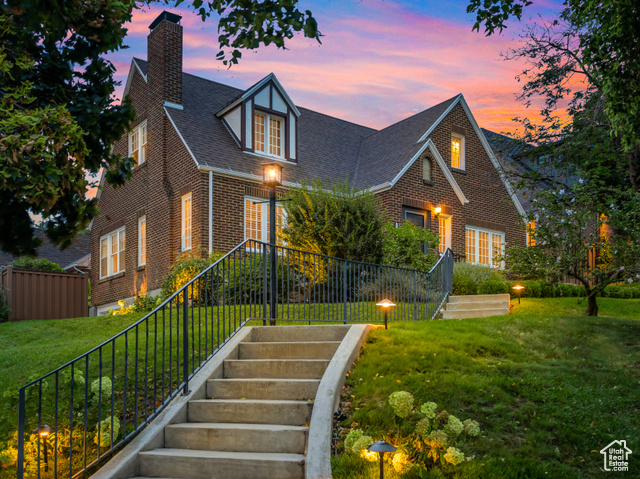 View of front of house featuring fully landscaped lawn