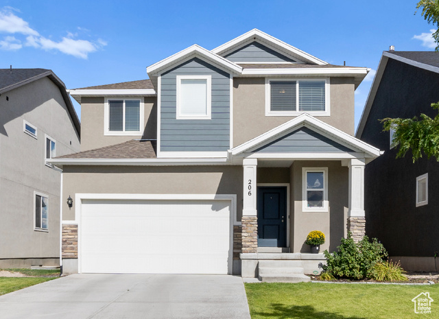 Craftsman-style house with a garage and a front yard