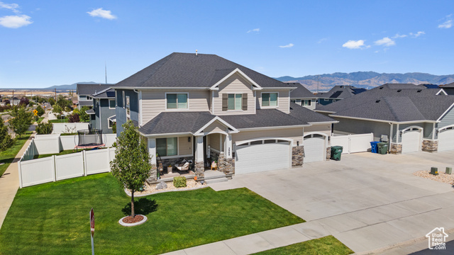 View of front of house with a mountain view and a front yard