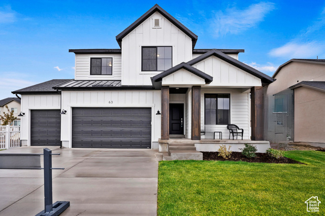 Modern farmhouse style home with a front yard