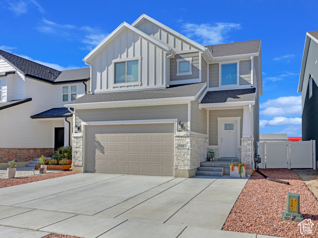 View of front of property featuring a garage and entry