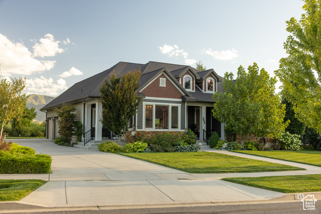 Craftsman-style home featuring a front lawn