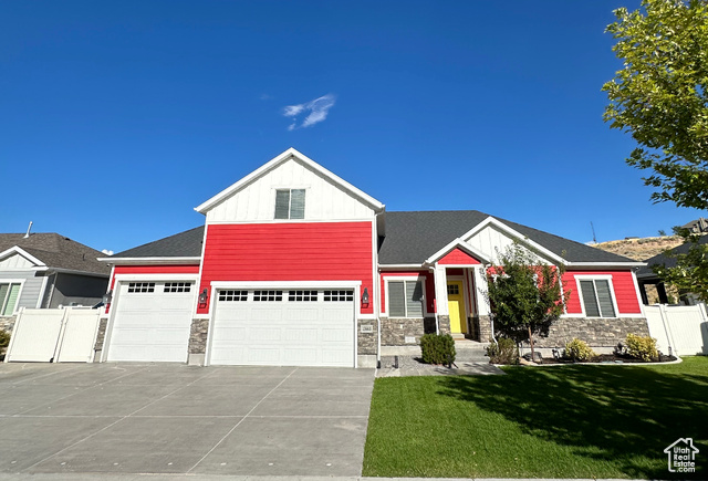 View of front of home featuring a garage and a front lawn