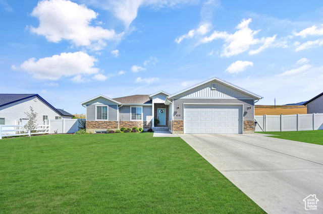 View of front of house with a front lawn and a garage