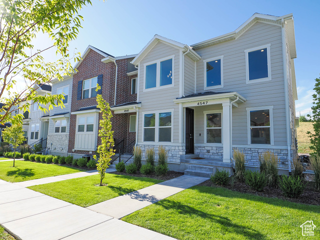 Gorgeous end unit townhome with fully landscaped front yard & no neighbors behind