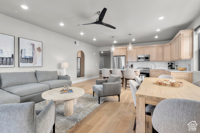 Living room featuring ceiling fan and light hardwood / wood-style floors