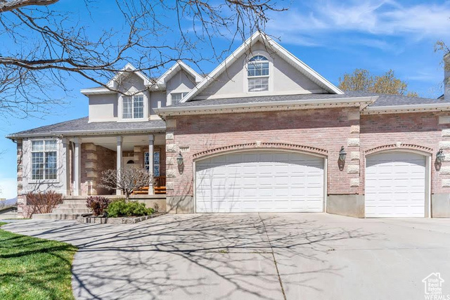 View of front of house featuring a garage and covered porch