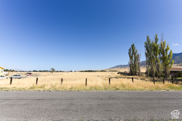 View of road with a rural view and a mountain view