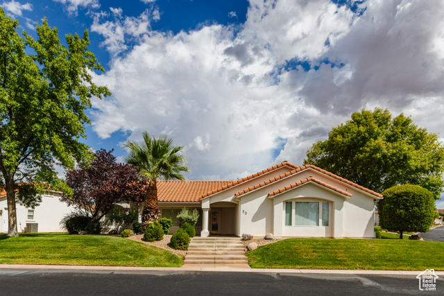 Mediterranean / spanish home featuring a front lawn