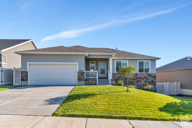 View of front of house with a front lawn and a garage