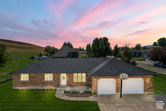 Ranch-style home with a yard and a garage