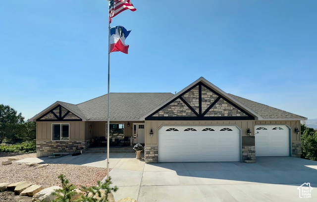 View of front facade with a oversized garage and beautifully landscaped