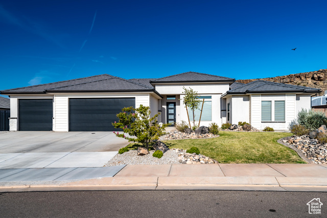 Prairie-style home with a garage and a front yard