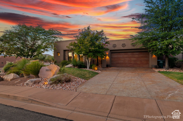 Pueblo-style home with a garage