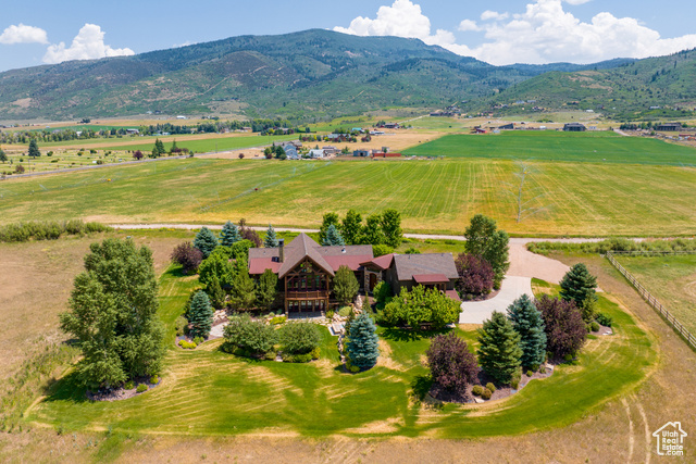 Birds eye view of property with a mountain view and a rural view