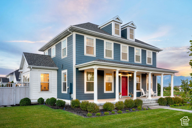 View of front of house featuring a yard and a porch