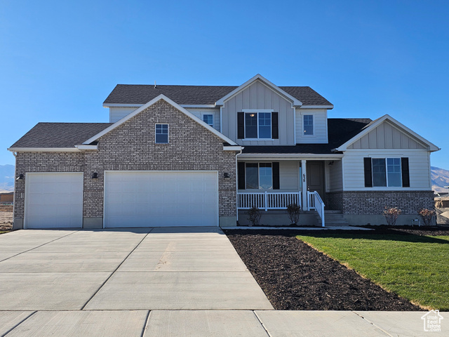 View of front facade with a porch and a front lawn