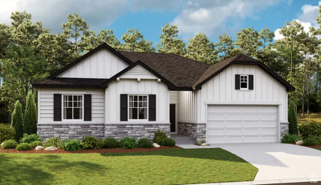 View of front of house featuring a garage and a front lawn